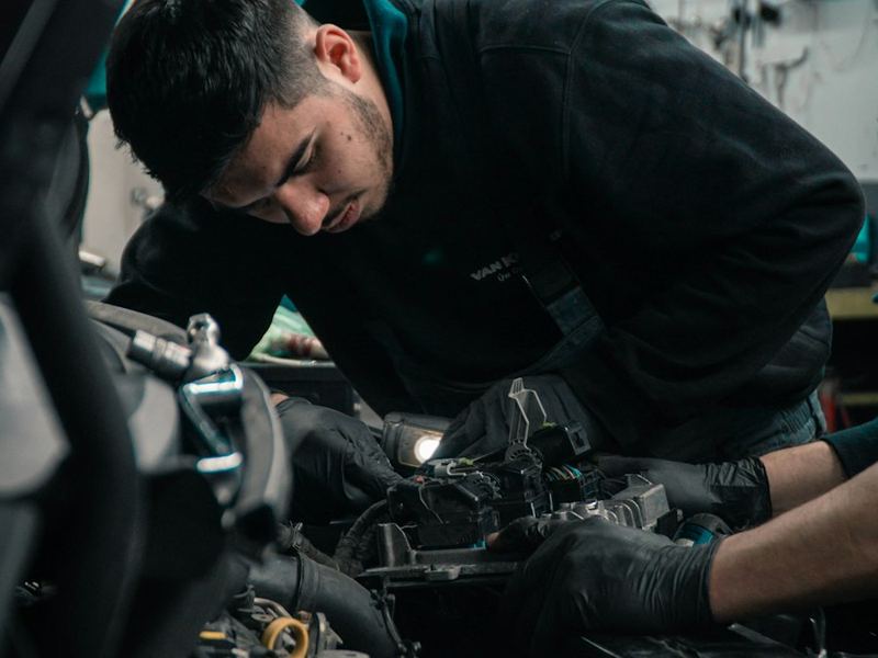 Mechanic working under the hood