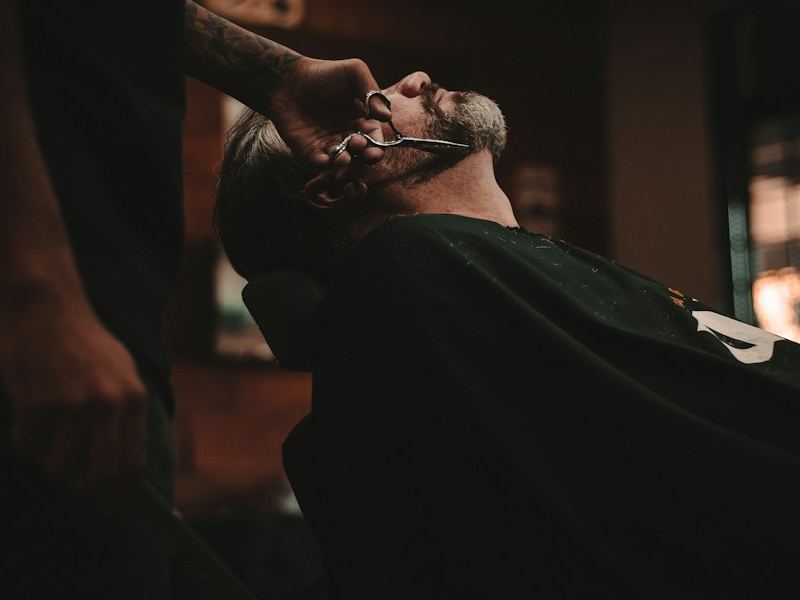 Barber trimming a beard