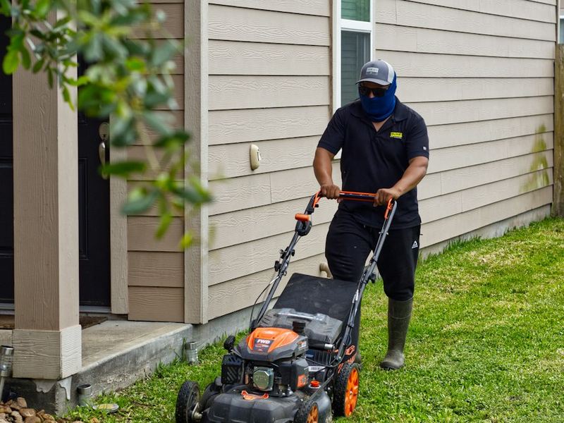 Mowing beside a house
