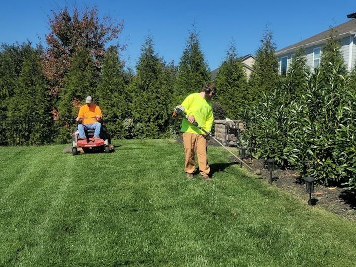 Crew mowing a large green lawn
